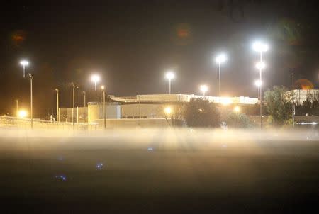 Fog drifts across a field in front of one of the two medium-security prisons inside the Federal Corrections Complex early in the morning in Butner, North Carolina November 20, 2015. REUTERS/Jonathan Drake