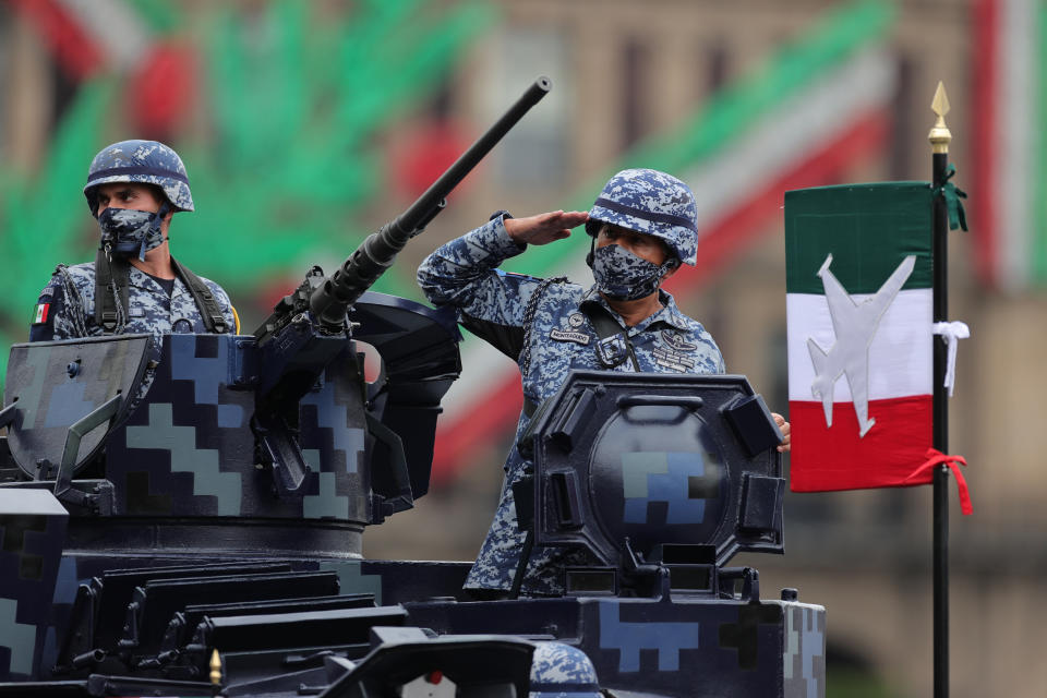 VARIOUS CITIES, MEXICO - SEPTEMBER 16: Soldiers look up towards President Andrés Manuel López Obrador during the Independence Day military parade at Zocalo Square on September 16, 2020 in Various Cities, Mexico. This year El Zocalo remains closed for general public due to coronavirus restrictions. Every September 16 Mexico celebrates the beginning of the revolution uprising of 1810. (Photo by Hector Vivas/Getty Images)