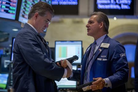 Traders work on the floor of the New York Stock Exchange August 12, 2014. REUTERS/Brendan McDermid