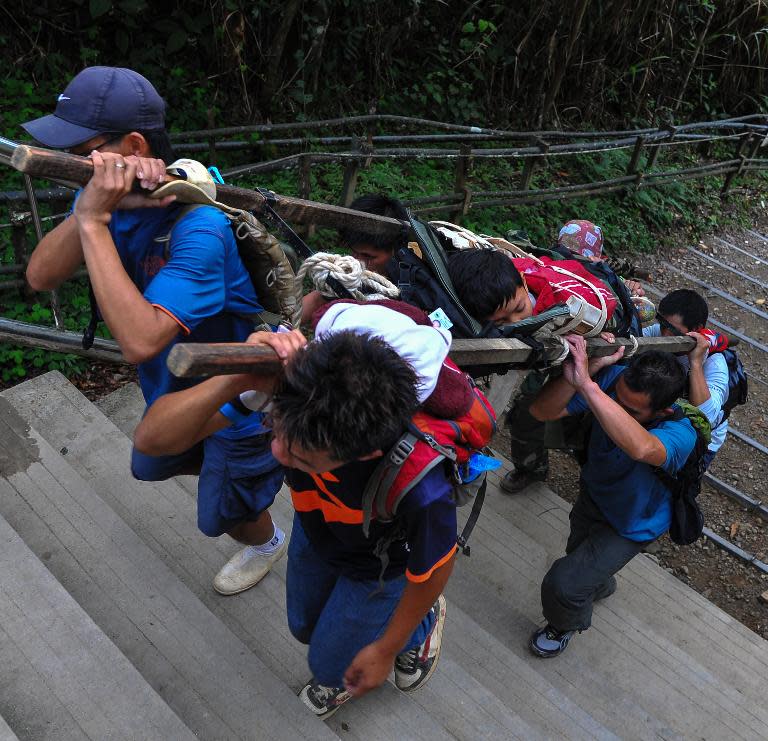 A Malaysian rescue team carries an injured Singaporean student after an earthquake near Mount Kinabalu on June 5, 2015, in this Malaysia Information Ministry photo