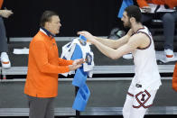 Illinois 's Giorgi Bezhanishvili, right, celebrates with head coach Brad Underwood during the second half of a first round NCAA college basketball tournament game against Drexel Friday, March 19, 2021, at the Indiana Farmers Coliseum in Indianapolis. Illinois won 78-49. (AP Photo/Charles Rex Arbogast)