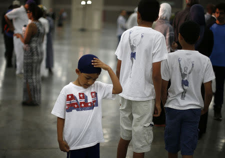 Zvair Ali, 5, arrives to take part in the jenazah, an Islamic funeral prayer, for the late boxing champion Muhammad Ali in Louisville, Kentucky, June 9, 2016. REUTERS/Lucy Nicholson