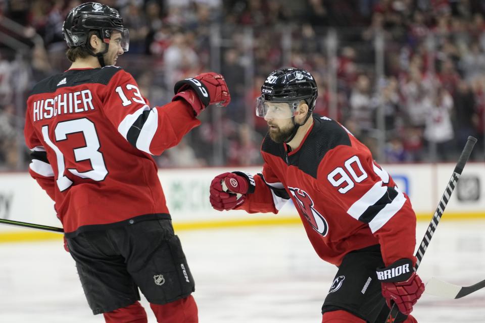 New Jersey Devils left wing Tomas Tatar, right, celebrates after scoring against the Columbus Blue Jackets, with center Nico Hischier (13) during the second period of an NHL hockey game Thursday, April 6, 2023, in Newark, N.J. (AP Photo/Mary Altaffer)