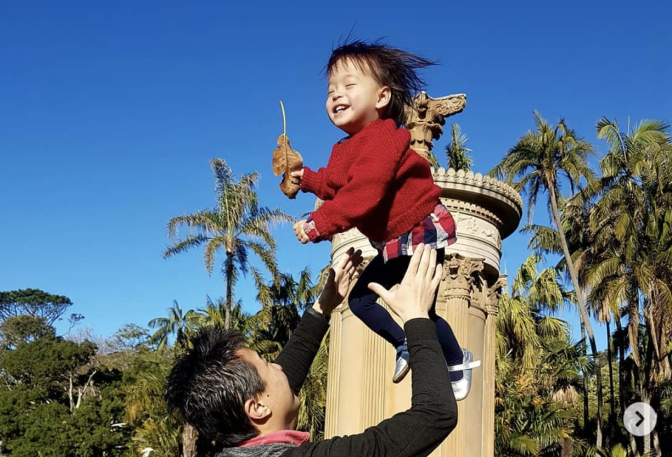 A young female toddler tossed into the air.