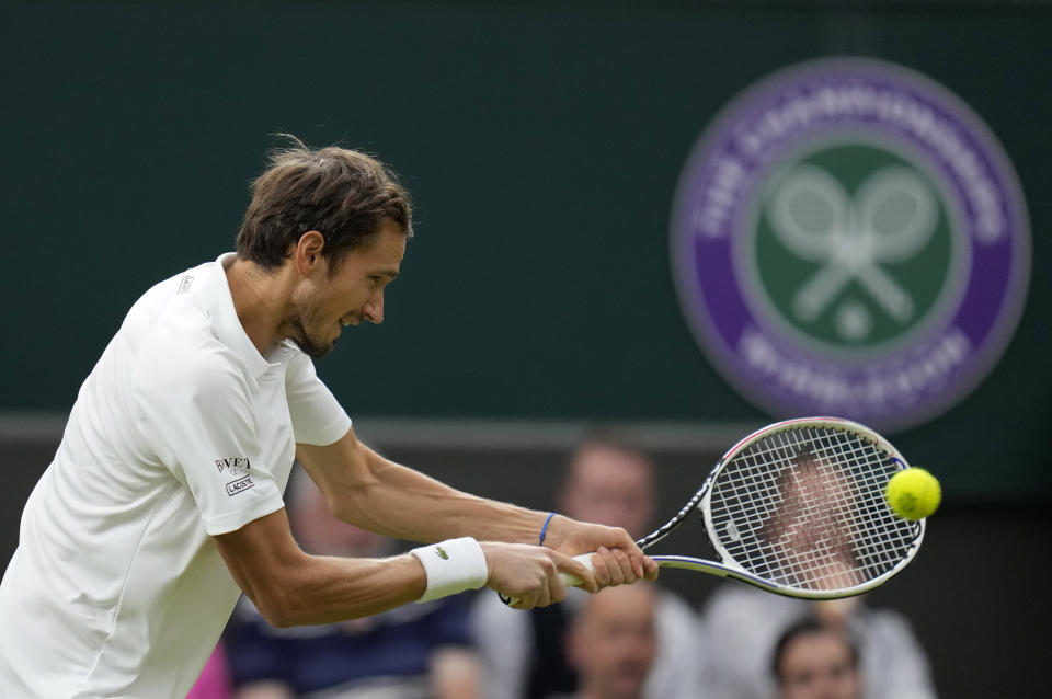 FILE - Russia's Daniil Medvedev plays a return to Poland's Hubert Hurkacz during the men's singles fourth round match on day eight of the Wimbledon Tennis Championships in London, Tuesday, July 6, 2021. Russian and Belarusian players will be able to compete at Wimbledon as neutral athletes after the All England Club on Friday, March 31, 2023, reversed its ban from last year. (AP Photo/Kirsty Wigglesworth, File)