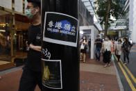 Stickers with messages of the pro-democracy movement are left by protesters on a street in Hong Kong, Thursday, July 2, 2020. Hong Kong police have made the first arrests under a new national security law imposed by mainland China, as thousands of people defied tear gas and pepper pellets to protest against it. Police say they arrested 10 people under the law, including at least one who was carrying a Hong Kong independence flag. (AP Photo/Kin Cheung)