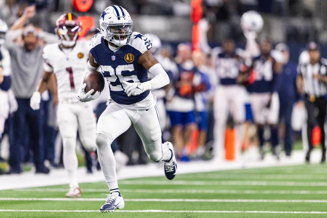 Dallas Cowboys cornerback DaRon Bland (26) runs to the end zone after an interception in the fourth quarter of the Thanksgiving NFL game against the Washington Commanders at AT&T Stadium in Arlington on Thursday, Nov. 23, 2023. With this pick six, Bland broke the record with five interceptions returned for a touchdown in a single season.