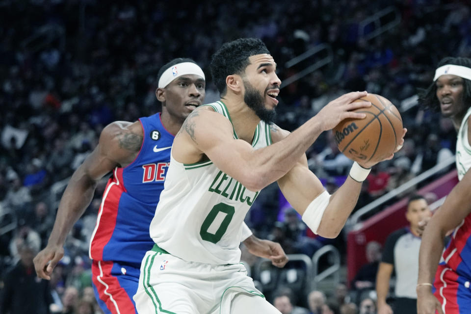 Boston Celtics forward Jayson Tatum (0) attempts a layup as Detroit Pistons guard Alec Burks defends during the first half of an NBA basketball game, Monday, Feb. 6, 2023, in Detroit. (AP Photo/Carlos Osorio)