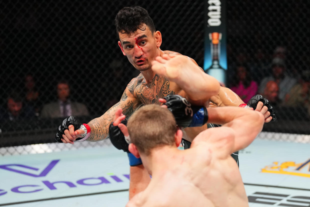 KANSAS CITY, MISSOURI - APRIL 15: (L-R) Max Holloway kicks Arnold Allen of England in a featherweight fight during the UFC Fight Night event at T-Mobile Center on April 15, 2023 in Kansas City, Missouri. (Photo by Josh Hedges/Zuffa LLC via Getty Images)