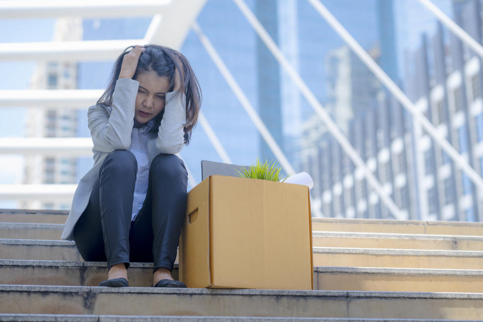 woman sitting outside her office after getting fired