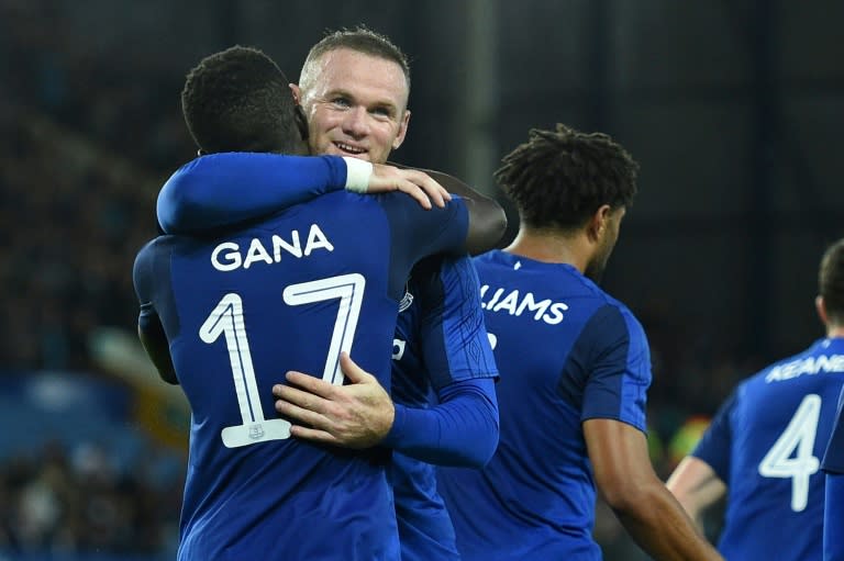 Everton's Idrissa Gueye (L) celebrates with teammate Wayne Rooney after scoring a goal during an UEFA Europa League match in Liverpool, on August 17, 2017