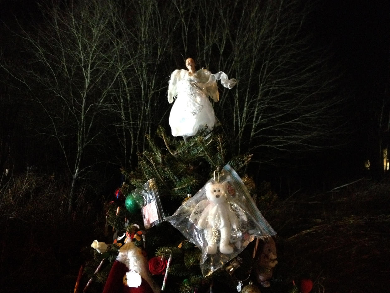 A Christmas tree decorated with ornaments, an angel and a teddy bear at a makeshift memorial near the entrance to Sandy Hook Elementary School in Newtown, Conn.