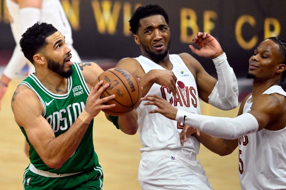 Celtics forward Jayson Tatum drives against Cavaliers defenders Donovan Mitchell (45) and Isaac Okoro in the first quarter of Game 3 of the Eastern Conference semifinals, May 11, 2024, in Cleveland.