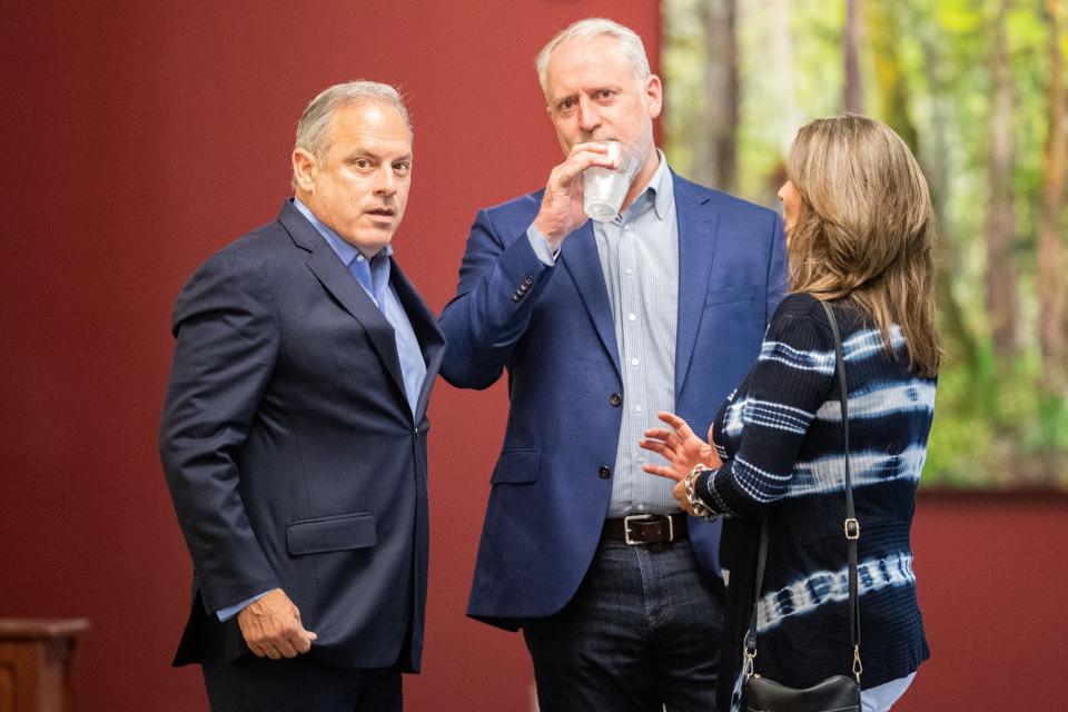 Drew Jones, center, points out the Tallahassee Democrat photojournalist to former Tallahassee City Commissioner Scott Maddox, left, and his former chief of staff Paige Carter-Smith, right, who have served their sentences for public corruption charges, following NAI TALCOR's Market Update Event at the Turnbull Center on Monday, March 25, 2024.