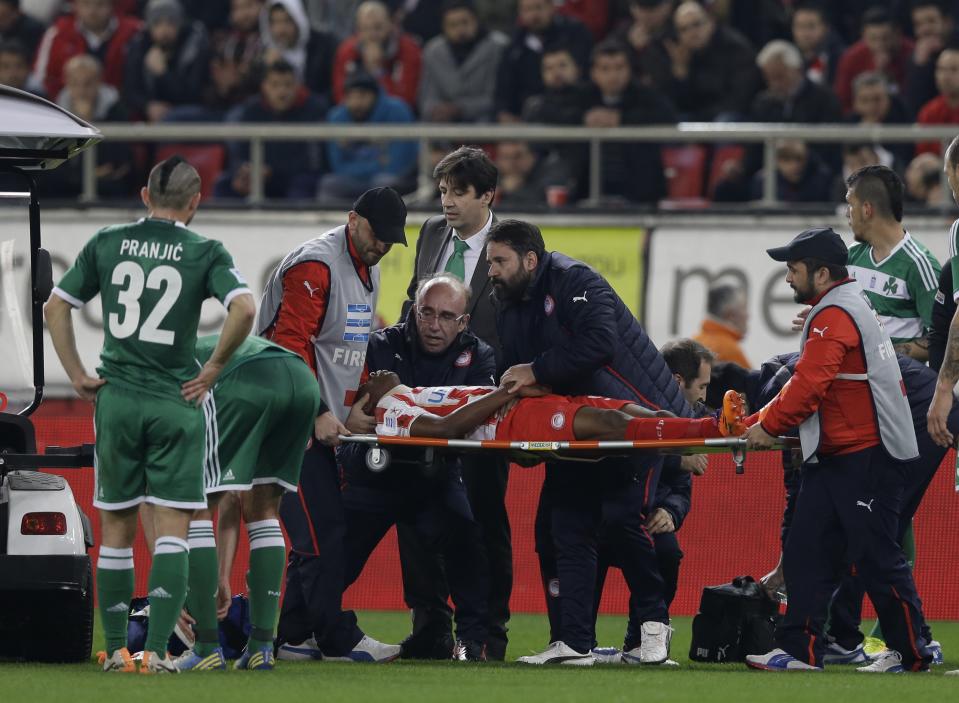 Olympiakos' Michael Olaitan of Nigeria leaves the pitch on a stretcher during a Greek League soccer match against Panathinaikos at Georgios Karaiskakis stadium, in Piraeus port, near Athens, on Sunday, March 2, 2014. Olaitan collapsed suddenly when walking alone on the field and hit his head upon falling. Panathinaikos won 3-0. (AP Photo/Thanassis Stavrakis)