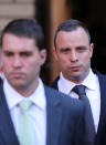 Oscar Pistorius with unidentified relative leaves at the high court in Pretoria, South Africa, Wednesday, May 14, 2014. Pistorius is charged with murder for the shooting death of his girlfriend, Reeva Steenkamp, on Valentines Day in 2013. A judge ruled on Wednesday, that Pistorius be sent for psychiatric observation. (AP Photo/Themba Hadebe)