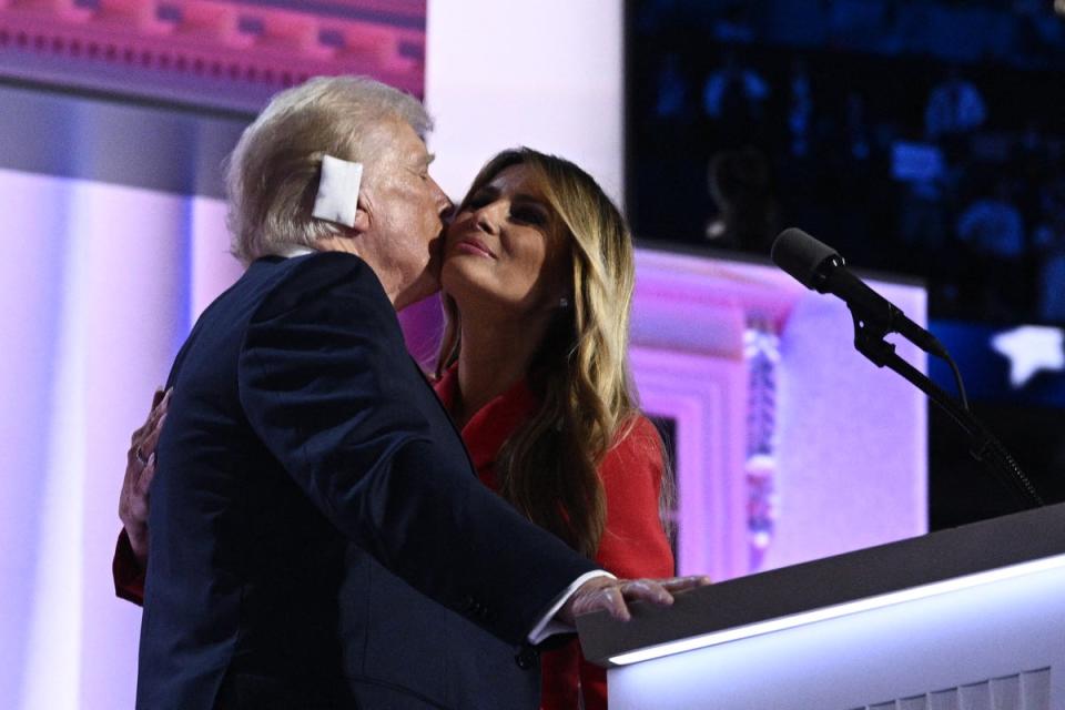 Former First Lady Melania Trump kisses US former president and 2024 Republican candidate Donald Trump as she joins him onstage on the last day of the 2024 Republican National Convention (AFP via Getty Images)