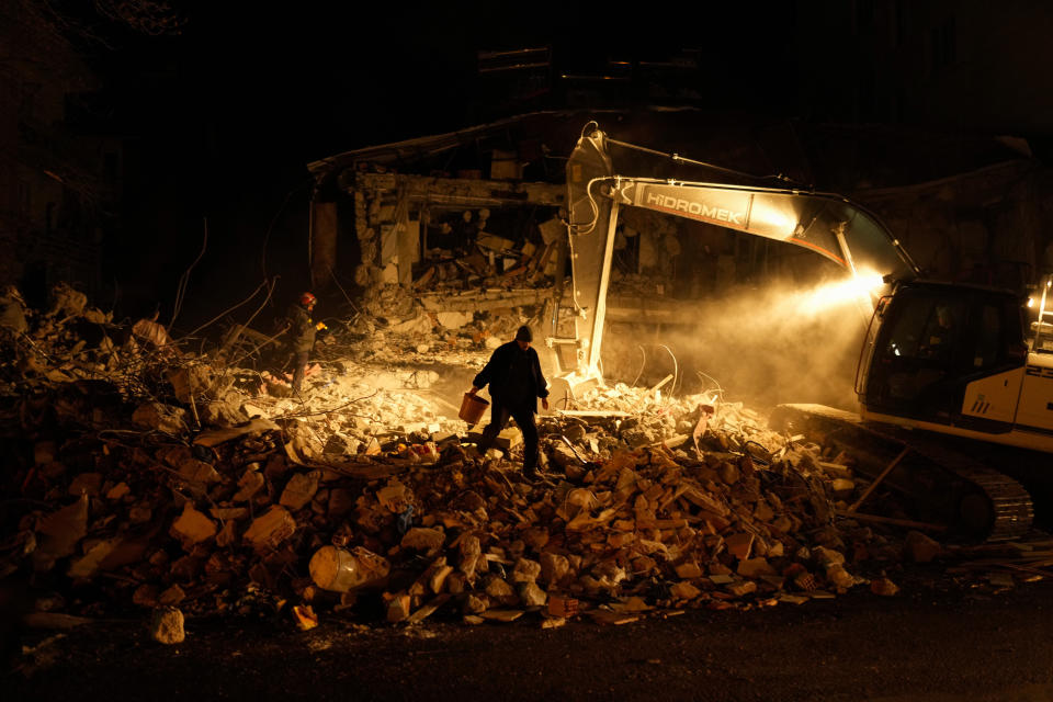 Rescue team members search for people in destroyed buildings in Elbistan, southern Turkey, Wednesday, Feb. 8, 2023. With the hope of finding survivors fading, stretched rescue teams in Turkey and Syria searched Wednesday for signs of life in the rubble of thousands of buildings toppled by a catastrophic earthquake. (AP Photo/Francisco Seco)