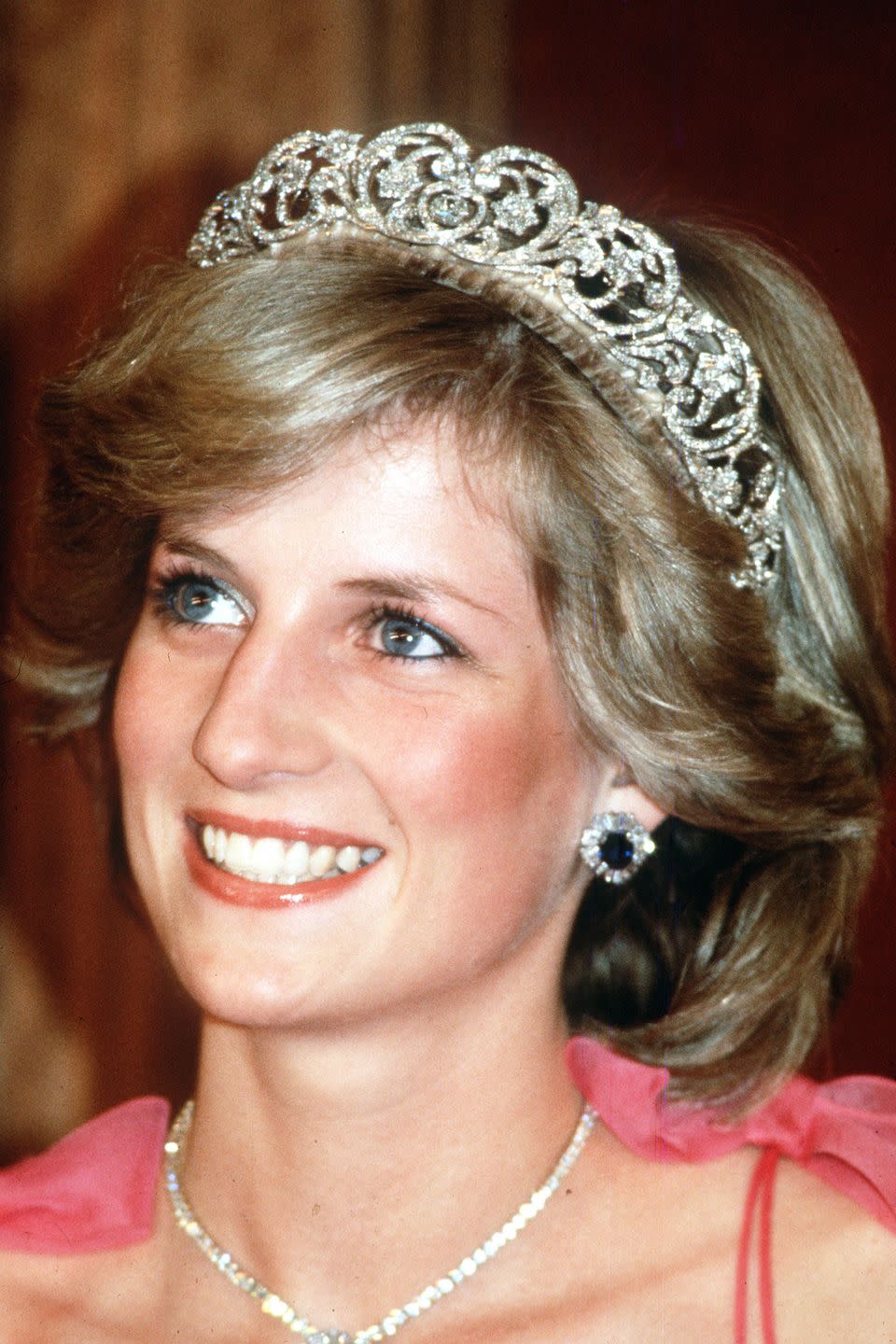 <p>In 1983, Princess Diana embarked on a major tour of Australia and New Zealand. At the state reception in Brisbane, she dressed up soft waves with the Spencer family tiara. </p>