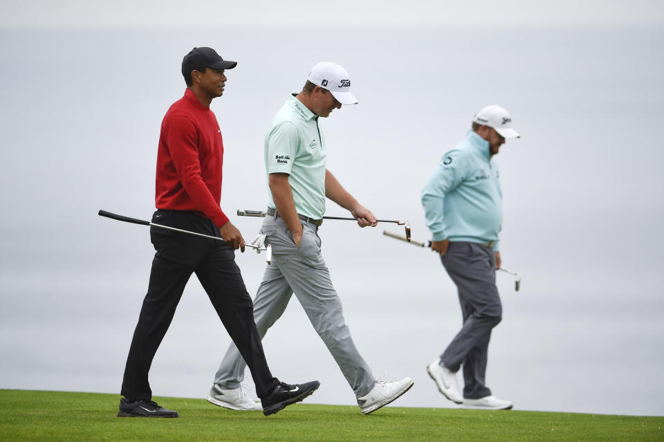 Tiger Woods, left, walks with Tom Hoge and J.B. Holmes on the fourth hole of the South Course at Torrey Pines Golf Course during the final round of the Farmers Insurance golf tournament Sunday, Jan. 26, 2020, in San Diego. (AP Photo/Denis Poroy)