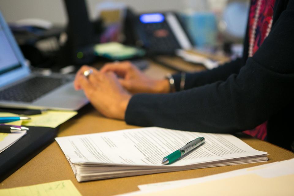 An educator goes over student resumes in her UD office, back in 2017.