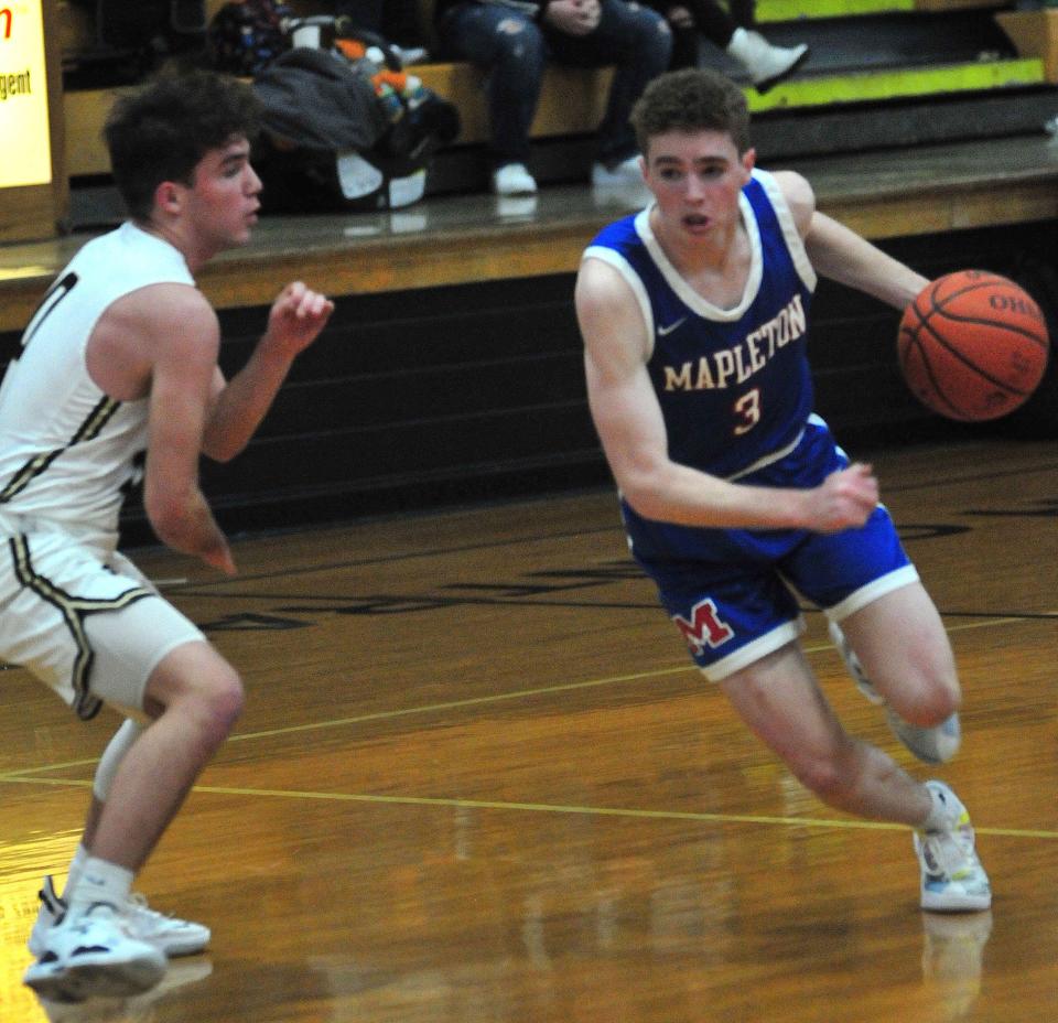 Mapleton High School's Cam Sloter (3) drives the ball around South Central High School's Kayden Hauler (0) during basketball action at South Central High School Thursday, Dec. 9, 2021.