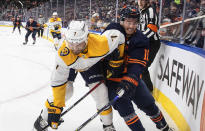 Nashville Predators' Matt Tennyson (7) checks Edmonton Oilers' Derek Ryan (10) during the second period of an NHL hockey game, Thursday, Jan. 27, 2022 in Edmonton, Alberta. (Jason Franson/The Canadian Press via AP)