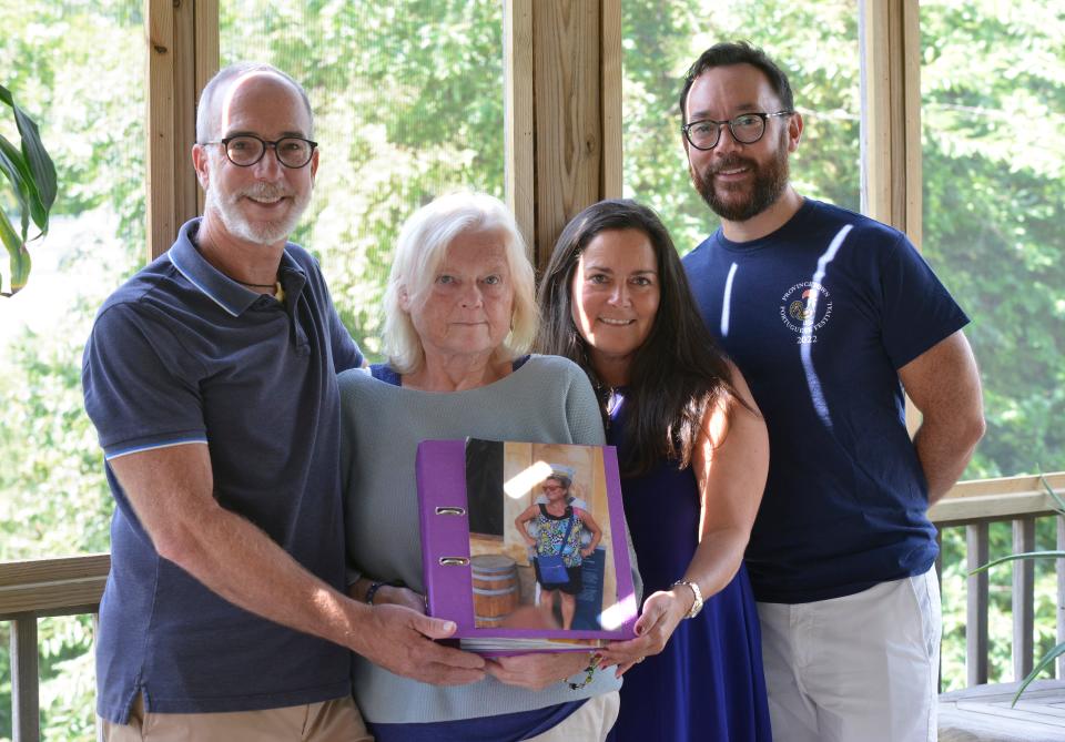 Peter Sullivan, left, his husband Bob Keary, right, and Amy Rogers, second from right, are photographed with Angelika Buhndorf, the mother of Rachel Schwolow who died last month. The photo that Buhndorf is holding is one of her favorite photos of her daughter taken in Puerto Rico in February 2020. Friends and family are helping to raise money for the Rachel Schwolow Foundation.