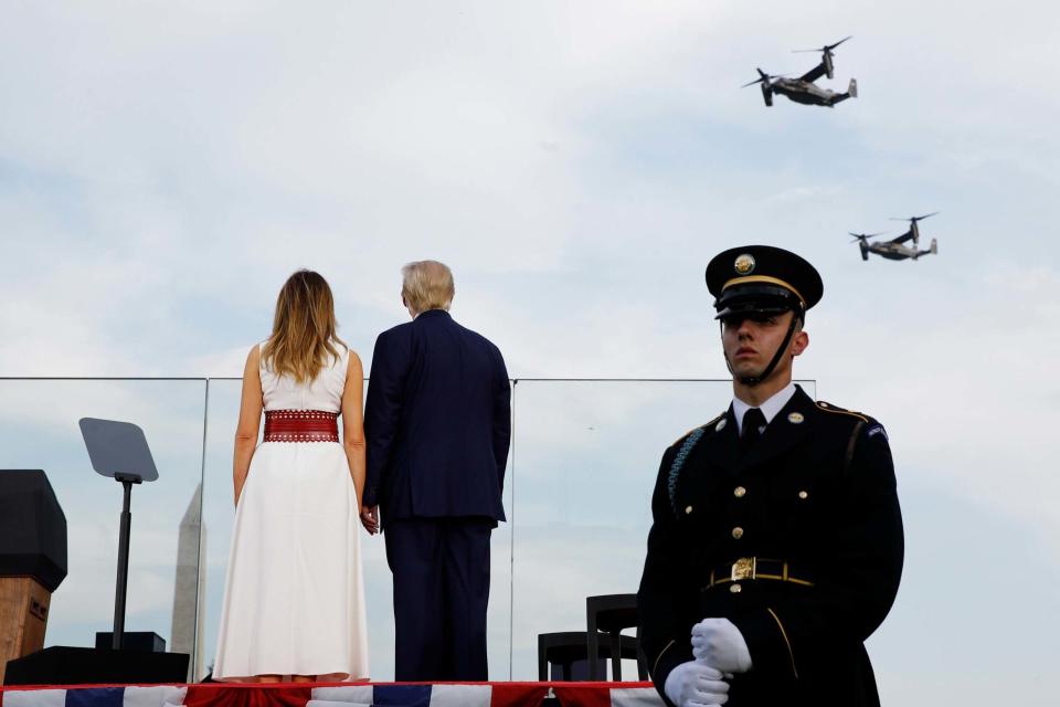 Donald Trump and first lady Melania Trump watch as V-22 Osprey aircraft perform a flyover (AP)