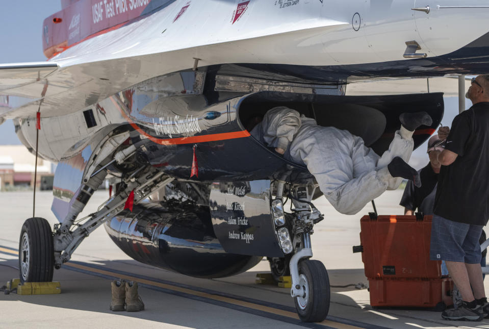 An Air Force mechanic checks the interior of the X-62A Variable Stability In-Flight Simulator Test Aircraft, or VISTA, after it performed several AI flight tests in which AI agents piloted to perform advanced fighter maneuvers against a human-crewed F-16 aircraft in the skies above Edwards Air Force Base, Calif., on Thursday, May 2, 2024. The flight is serving as a public statement of confidence in the future role of AI in air combat. The military is planning to use the technology to operate an unmanned fleet of 1,000 aircraft. (AP Photo/Damian Dovarganes)