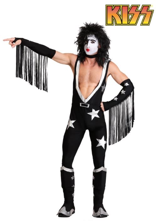 model wearing low v-neck jumpsuit with stars, face paint and armbands with fringe