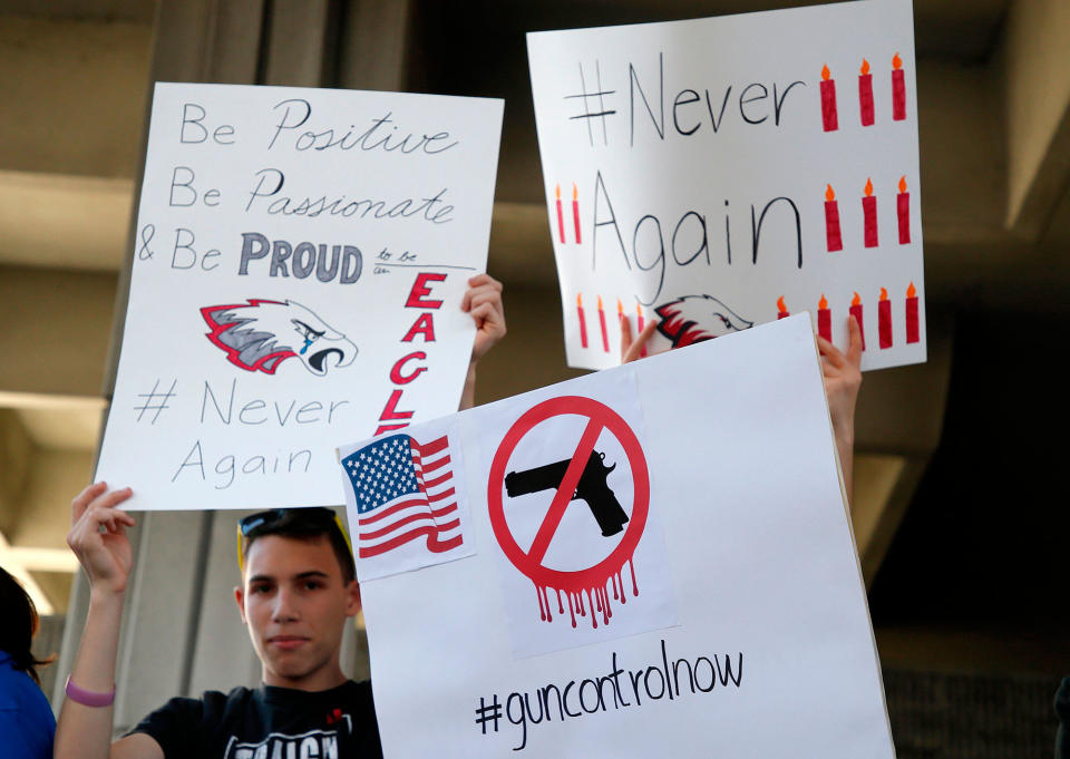 <p>Protesters hold signs at a rally for gun control at the Broward County Federal Courthouse in Fort Lauderdale, Fla., Feb. 17, 2018. (Photo: Rhona Wise/AFP/Getty Images) </p>