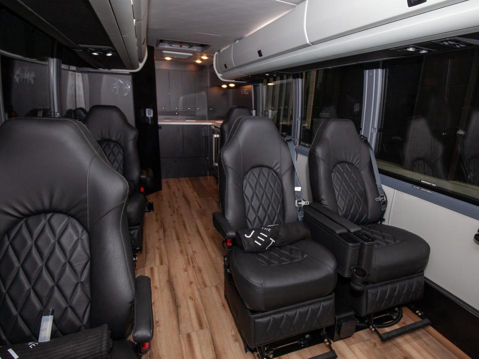 rows of seats inside one of the Jet's buses