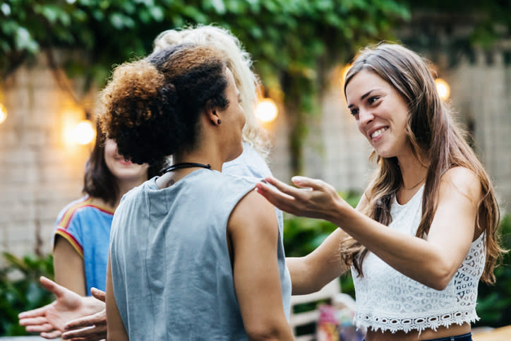 A woman greeting her friends