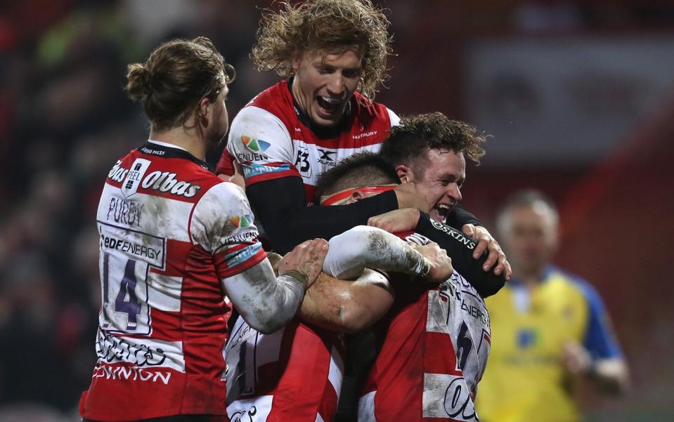 Jake Polledri of Gloucester is mobbed by his team mates after scoring a try against London Irish on Saturday - Getty Images Europe