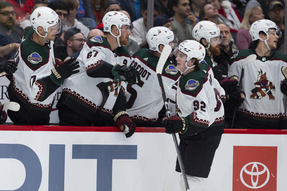 Arizona Coyotes center Logan Cooley (92) celebrates with teammates after his goal during the first period of an NHL hockey game against the Washington Capitals, Sunday, March 3, 2024, in Washington. (AP Photo/Manuel Balce Ceneta)