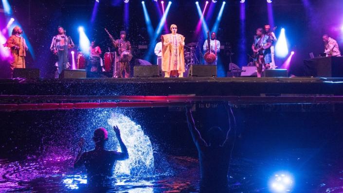 A band performing on a floating stage on 22 July 2023