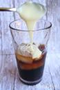 <p>Add a large dollop of sweetened, condensed milk for a rich, creamy version.</p><p>Get the tutorial from <a href="http://dukesandduchesses.com/2013/06/vietnamese-iced-coffee?showComment=1371228647929#c7590057986817475" rel="nofollow noopener" target="_blank" data-ylk="slk:Dukes and Duchesses;elm:context_link;itc:0;sec:content-canvas" class="link ">Dukes and Duchesses</a>.</p>