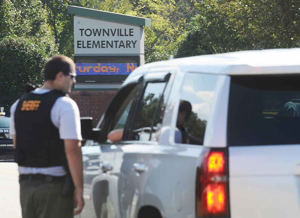 <p>Members of law enforcement talk in front of Townville Elementary School on Wednesday, Sept. 28, 2016, in Townville, S.C. A teenager opened fire at the South Carolina elementary school Wednesday, wounding two students and a teacher before the suspect was taken into custody, authorities said. (AP Photo/Rainier Ehrhardt) </p>