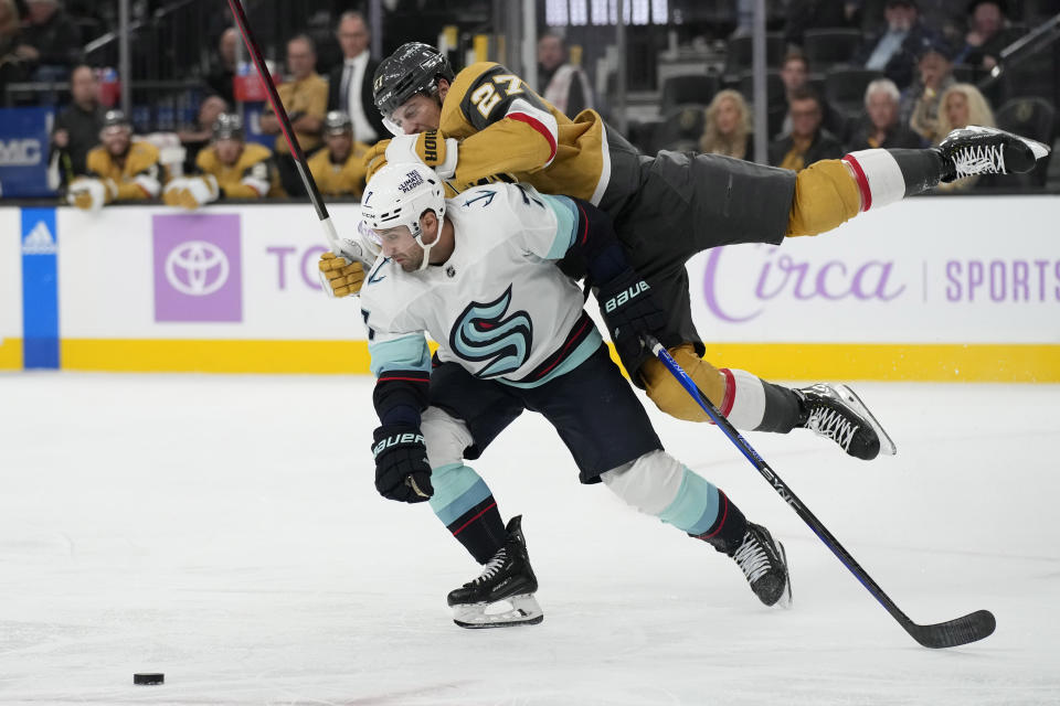 Vegas Golden Knights defenseman Shea Theodore, right, collides with Seattle Kraken right wing Jordan Eberle (7) during the third period of an NHL hockey game Friday, Nov. 25, 2022, in Las Vegas. (AP Photo/John Locher)