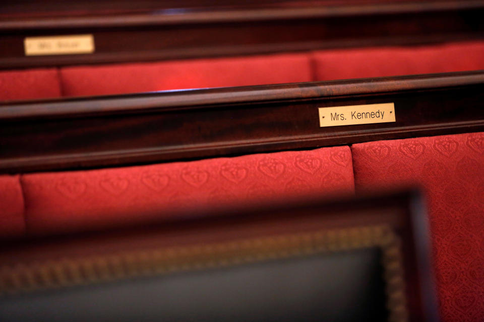 Name plates mark the spaces reserved for justices' families in the courtroom.