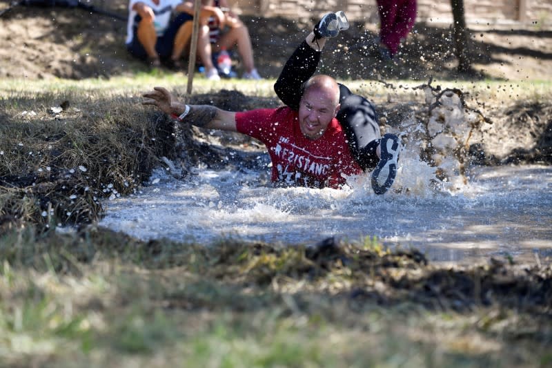 Participants compete in a wife-carrying championship