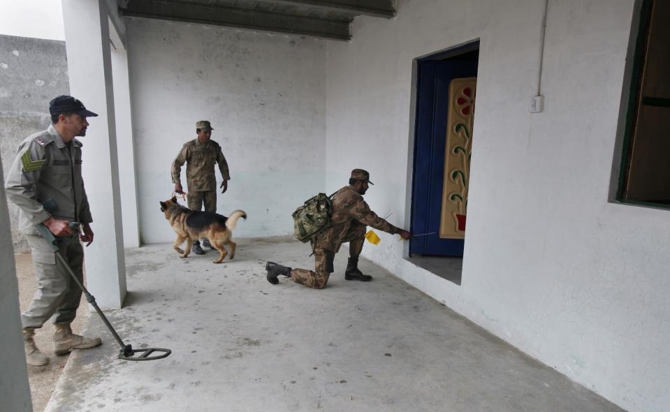 In this Wednesday, Jan. 8, 2014, photo, Pakistani soldiers search a model house during a training session at the Counter IED Explosives and Munitions School in Risalpur, Pakistan. Militants in Pakistan have become devilishly ingenious about where they plant improvised explosive devices, a type of bomb responsible for thousands of wounds and deaths in Pakistan. They’ve been found strapped to children’s bicycles, hidden inside water jugs and even hung in tree branches. (AP Photo/Anjum Naveed)