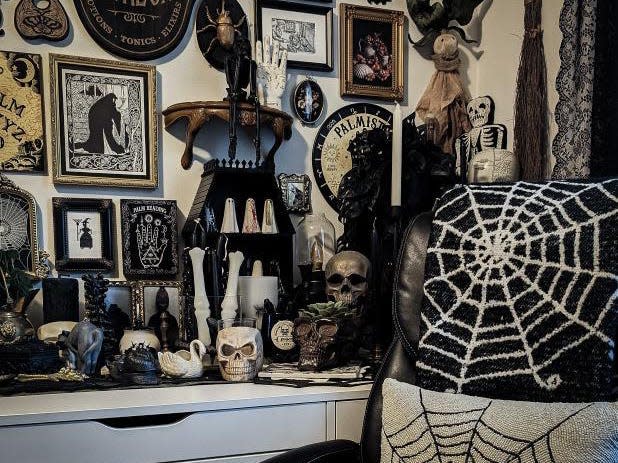 Naomi collects dark Victorian and Gothic-inspired decor items like skulls, Ouija boards, and wall art.
