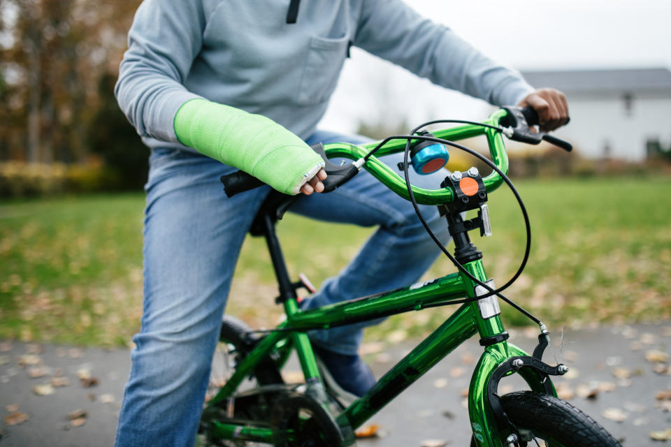 Person with a cast on their arm riding a bike