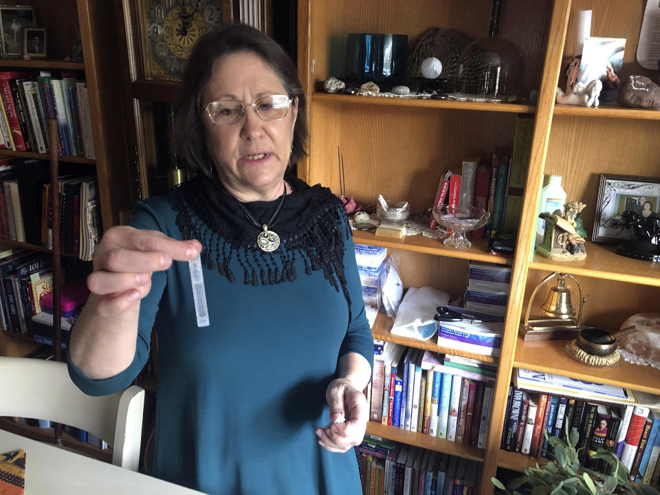 Barbara Trout, who has an asthma disorder, holds a vial of inhalation solution of Ipratropium Bromide and Albuterol Sulfate, prescribed medication at her home in Keizer, Ore., Wednesday, Oct. 14, 2020. (AP Photo/Andrew Selsky)