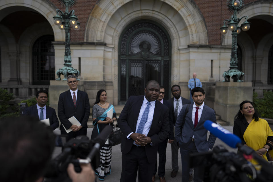 Gambia's attorney general Dawda Jallow, center, and representatives of Rohingya organizations comment outside the International Court of Justice in The Hague, Netherlands, Friday, July 22, 2022, where judges of the UN court dismissed Myanmar's preliminary objections, saying it has jurisdiction in Rohingya genocide case. (AP Photo/Peter Dejong)