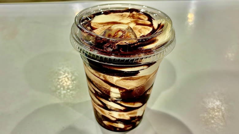 Ice cream cup with chocolate syrup
