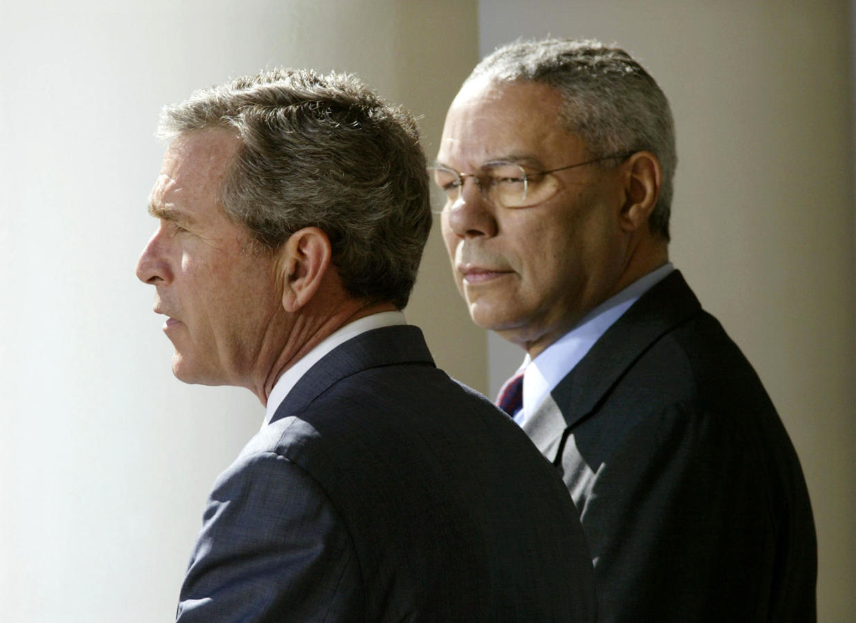 President George W. Bush stands with Secretary of State Colin Powell in the Rose Garden, March 14, 2003. (Gary Hershorn/Reuters)