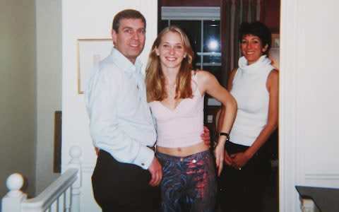 Prince Andrew smiling as he stands with his left arm around the waist of Virginia Roberts. It is alleged to have been taken in early 2001. Ghislaine Maxwell stands behind. - Credit: AKGS&nbsp;